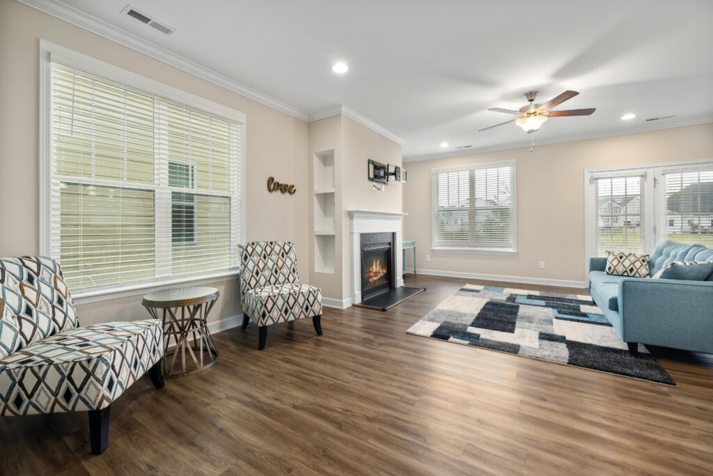 Spacious and stylish living room with fireplace and modern decor.